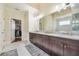 Bathroom with double vanity, marble floors, glass shower, walk-in closet, and granite countertops at 2417 Siesta Ct, Marietta, GA 30062