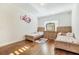 Bright bedroom with twin beds, hardwood floors, and natural light streaming through the window at 2417 Siesta Ct, Marietta, GA 30062