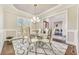 Bright dining room with a modern glass table, unique chairs, and a decorative chandelier at 2417 Siesta Ct, Marietta, GA 30062