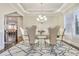 Formal dining room with elegant chandelier, modern rug, and refined decor at 2417 Siesta Ct, Marietta, GA 30062