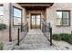 Inviting front entrance with brick steps, iron railings, and double doors at 2417 Siesta Ct, Marietta, GA 30062