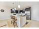 The kitchen's island and bar stool seating enhance the design with stylish lighting and stainless steel appliances at 2417 Siesta Ct, Marietta, GA 30062