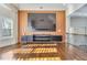 Stylish living room features a modern entertainment center, hardwood floors, and natural light from the window at 2417 Siesta Ct, Marietta, GA 30062