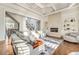 Sunlit living room boasts a coffered ceiling, stone fireplace, and soft gray furnishings at 2417 Siesta Ct, Marietta, GA 30062