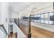 Upstairs loft featuring hardwood floors, a view of the great room, and elegant railing details at 2417 Siesta Ct, Marietta, GA 30062