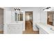 Bathroom featuring dual sinks and mirrors with connecting room views at 499 Bellbrook Ln, Lawrenceville, GA 30045