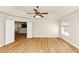 Spacious bedroom featuring a ceiling fan, tray ceiling and doorway to kitchen at 499 Bellbrook Ln, Lawrenceville, GA 30045