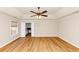 Spacious bedroom featuring tray ceiling, ceiling fan and an open doorway at 499 Bellbrook Ln, Lawrenceville, GA 30045