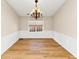 Traditional dining room with wainscoting, chandelier, and views from large window at 499 Bellbrook Ln, Lawrenceville, GA 30045