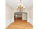 Elegant dining room featuring wainscoting, chandelier, and entryway to living space at 499 Bellbrook Ln, Lawrenceville, GA 30045