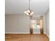 Bright dining room with chandelier lighting, window, and neutral walls at 499 Bellbrook Ln, Lawrenceville, GA 30045