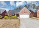 Charming brick home with a two-car garage, inviting front yard, and a well-maintained lawn at 499 Bellbrook Ln, Lawrenceville, GA 30045