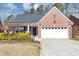 Charming brick home with a two-car garage, inviting front yard, and a well-maintained lawn at 499 Bellbrook Ln, Lawrenceville, GA 30045