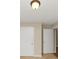 Hallway featuring white paneled doors and neutral walls, leading to multiple rooms at 499 Bellbrook Ln, Lawrenceville, GA 30045