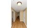 Hallway with hardwood floors and neutral paint provides passage to multiple rooms at 499 Bellbrook Ln, Lawrenceville, GA 30045