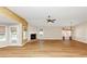 Open living room features hardwood floors, a cozy fireplace, and natural light at 499 Bellbrook Ln, Lawrenceville, GA 30045