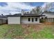 View of backyard featuring white siding, black trim and a patio area at 5393 Ridge Forest Dr, Stone Mountain, GA 30083