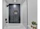 Elegant white bathroom with black marble shower and modern fixtures for a luxurious feel at 5393 Ridge Forest Dr, Stone Mountain, GA 30083