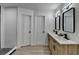 Bright bathroom featuring double vanity with wooden cabinets and dual mirrors at 5393 Ridge Forest Dr, Stone Mountain, GA 30083