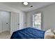 Cozy bedroom with a blue quilt, wood floors, and a bright window for natural light at 5393 Ridge Forest Dr, Stone Mountain, GA 30083