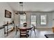 Bright dining area with a wooden table, natural light, and views to the backyard at 5393 Ridge Forest Dr, Stone Mountain, GA 30083