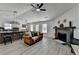 Open-concept living area with kitchen island, seating, and a cozy fireplace at 5393 Ridge Forest Dr, Stone Mountain, GA 30083