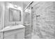 Beautiful bathroom with a marble vanity, stylish lighting, and a sleek glass-enclosed shower with decorative tiling at 609 Old Wheat Ne St, Atlanta, GA 30312