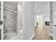 Modern bathroom featuring a gray-tiled shower with a glass door and updated fixtures and a fireplace in view at 609 Old Wheat Ne St, Atlanta, GA 30312