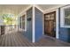 Charming front porch featuring wood flooring, wood door, mailbox, and blue siding at 609 Old Wheat Ne St, Atlanta, GA 30312