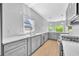 Open kitchen featuring gray cabinetry, stainless steel appliances, and white countertops at 609 Old Wheat Ne St, Atlanta, GA 30312