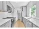 Modern kitchen featuring stainless steel appliances, gray cabinets and access to a walk-in pantry at 609 Old Wheat Ne St, Atlanta, GA 30312