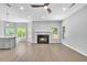 Bright living room featuring a fireplace, ceiling fan, and large windows offering natural light at 609 Old Wheat Ne St, Atlanta, GA 30312