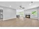 Open-concept living area with hardwood floors, a modern fireplace, and a seamless transition to the kitchen at 609 Old Wheat Ne St, Atlanta, GA 30312