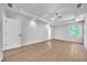 Bright main bedroom showcasing hardwood floors, tray ceiling, and a ceiling fan at 609 Old Wheat Ne St, Atlanta, GA 30312