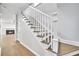 Elegant staircase with white railing and wooden steps, leading to an upper level with view of fireplace at 609 Old Wheat Ne St, Atlanta, GA 30312