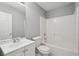 Bathroom with a white vanity, matching toilet and a shower-tub combo at 1542 Bogota Way, Jonesboro, GA 30236