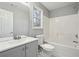 Bathroom featuring a tub and shower combo, vanity, toilet and a window at 1542 Bogota Way, Jonesboro, GA 30236