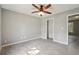 Bedroom features gray paint, wood floors, ceiling fan and a walk-in closet at 1542 Bogota Way, Jonesboro, GA 30236