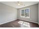 Sun-lit bedroom with hardwood floors, ceiling fan, and a large window with natural light at 1542 Bogota Way, Jonesboro, GA 30236