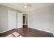 Well-lit bedroom with hardwood floors, ceiling fan, and access to an ensuite bathroom and closet at 1542 Bogota Way, Jonesboro, GA 30236