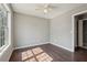 Neutral bedroom with wood floors and a door leading to the adjoining hallway at 1542 Bogota Way, Jonesboro, GA 30236