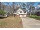 Classic home featuring a front facing two-car garage and staircase to front door at 1542 Bogota Way, Jonesboro, GA 30236