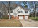 Charming two-story home features a two-car garage, inviting entrance and beautiful front yard at 1542 Bogota Way, Jonesboro, GA 30236