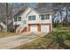 Lovely home with a two-car garage and a staircase to the front entrance, surrounded by a yard at 1542 Bogota Way, Jonesboro, GA 30236