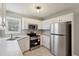 Charming kitchen featuring plenty of cabinet space, modern appliances, and tile flooring at 1542 Bogota Way, Jonesboro, GA 30236