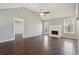 Bright living room featuring hardwood floors, a fireplace, a ceiling fan, and natural light at 1542 Bogota Way, Jonesboro, GA 30236