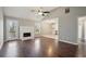 Bright living room featuring hardwood floors, fireplace, and a doorway to the kitchen at 1542 Bogota Way, Jonesboro, GA 30236