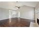 Spacious living room featuring a vaulted ceiling, wood floors, and a decorative fireplace at 1542 Bogota Way, Jonesboro, GA 30236