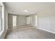 Bright and airy living room with grey paint and hardwood floors at 1542 Bogota Way, Jonesboro, GA 30236