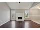 Bright living room featuring hardwood floors, fireplace, and a doorway to the kitchen at 1542 Bogota Way, Jonesboro, GA 30236